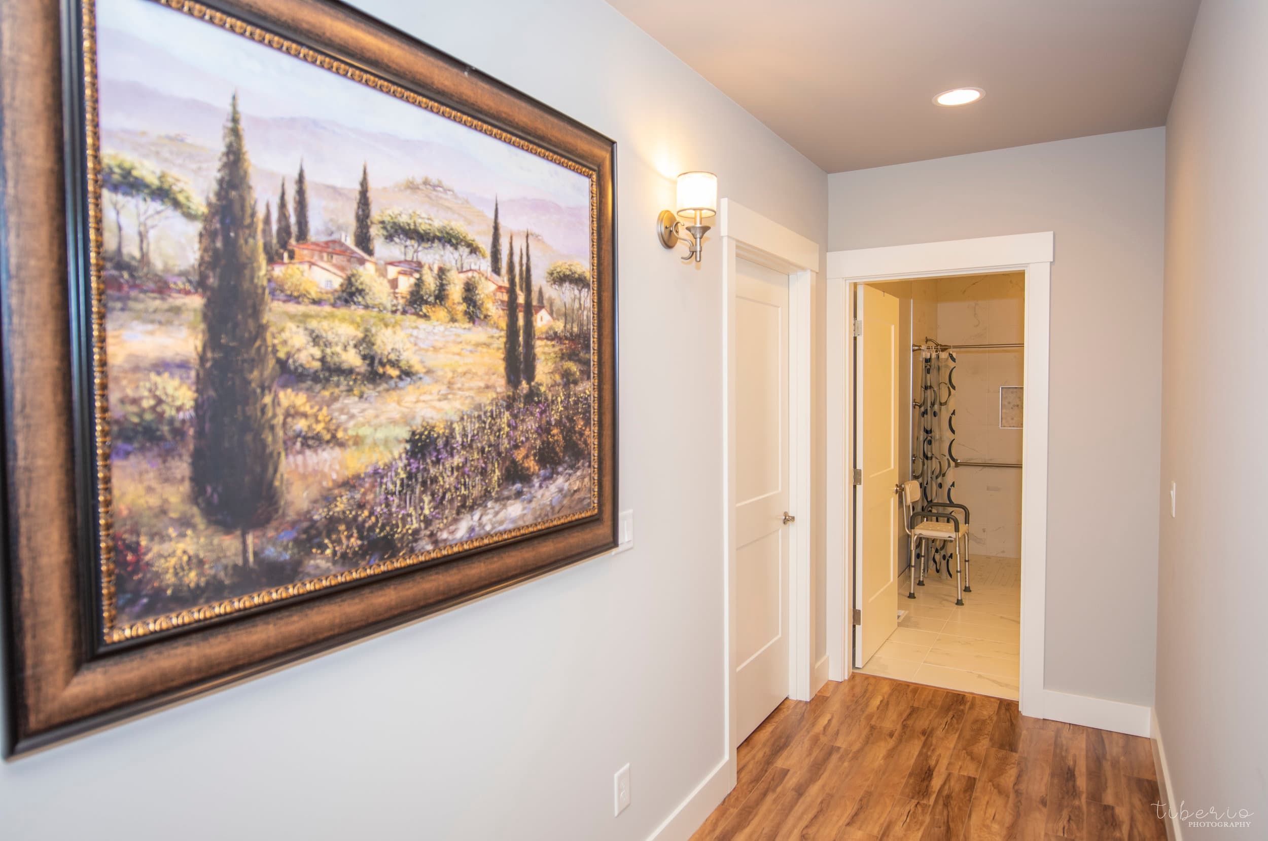 Artwork and an accessible bathroom entry inside Kenmore Retreat